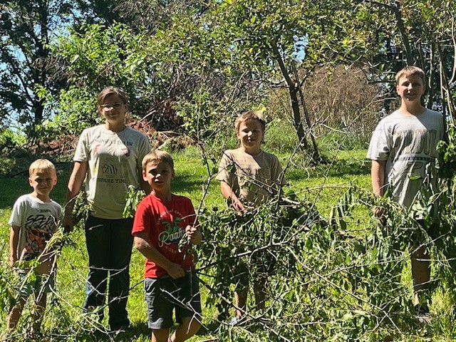 Kids helping clear brush